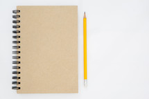 notebook and pencil on white background 