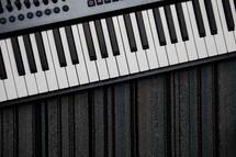 digital piano keyboard on a rug