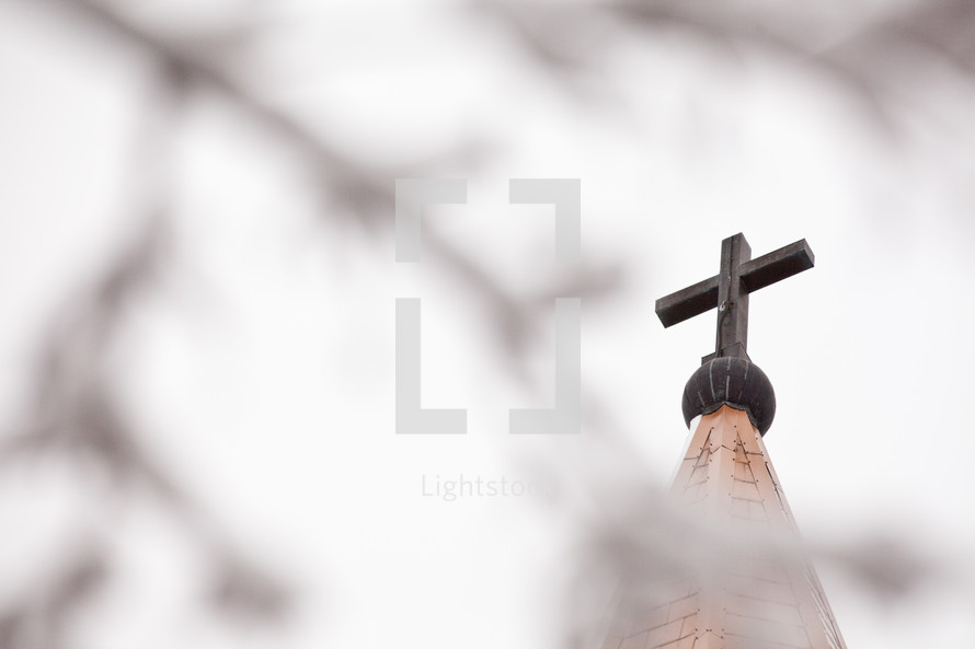 cross topper on top of a church steeple