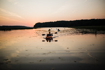 paddling kayaks at sunset 