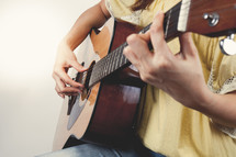 a woman playing a guitar 