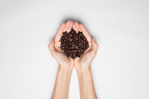 coffee beans in cupped hands 