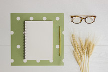 journal, polkadots, wheat, gold pen, and reading glasses 