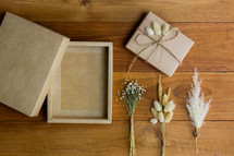 brown paper gift box and fuzzy grasses 