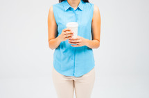 torso of a woman holding a coffee cup 