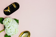 hydrangea flowers, gold dish, and gifts on a pink background 