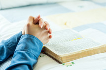 praying beside the bed with a bible