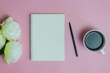 blank pages of a journal on a pink background 