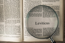 magnifying glass over Bible - Leviticus 