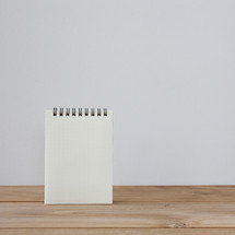 notepad on a wood desk 