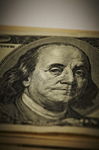 A closeup of a stack of one hundred dollar bills - Benjamin Franklin