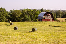 red barn and hay bales 