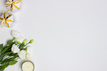 white roses and candles on a white background 