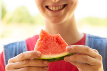a woman eating watermelon 
