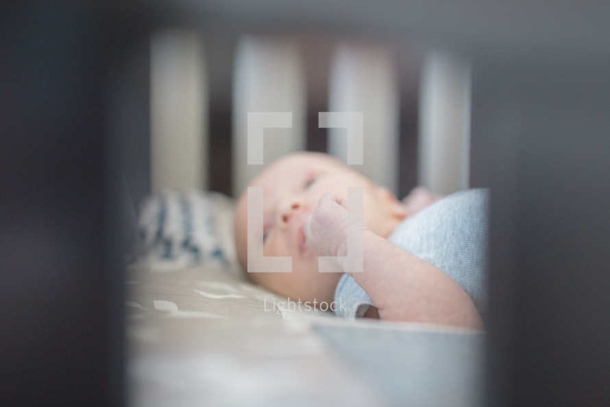 a newborn in a crib 