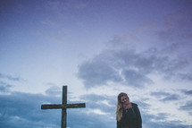 woman standing near a cross