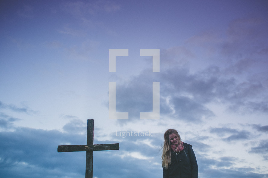 woman standing near a cross