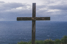 wood cross near the ocean 