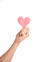 hand holding a paper heart up in the air