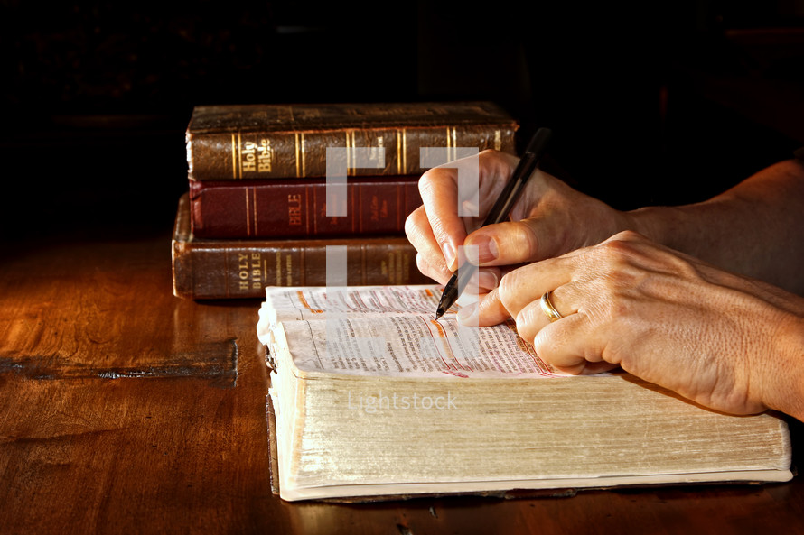 a man reading a Bible and underlining scripture 