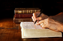 a man reading a Bible and underlining scripture 