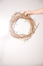 hand holding a crown of thorns