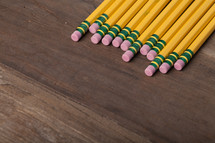 pencils with erasers on a wood table 