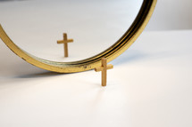 reflection of a cross in a mirror 