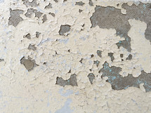 cracked, peeling paint on a concrete surface