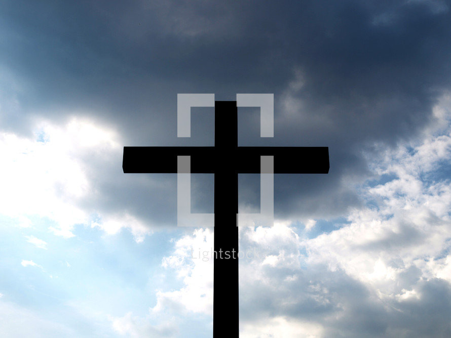 Christian cross silhouette over a cloudy sky background