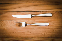 fork and knife on a wood floor 