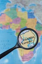 magnifying glass over a map of Uganda 