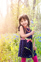 little girl picking wildflowers 