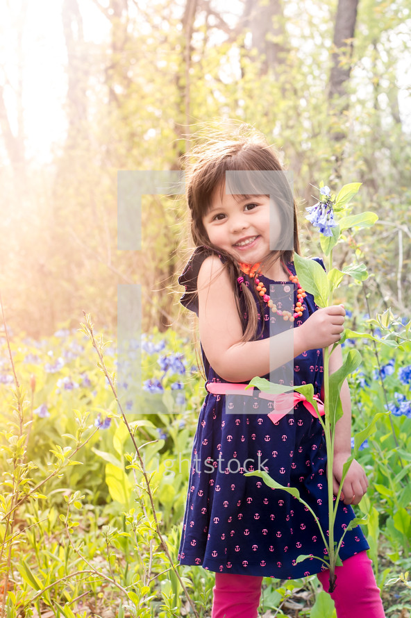 little girl picking wildflowers 