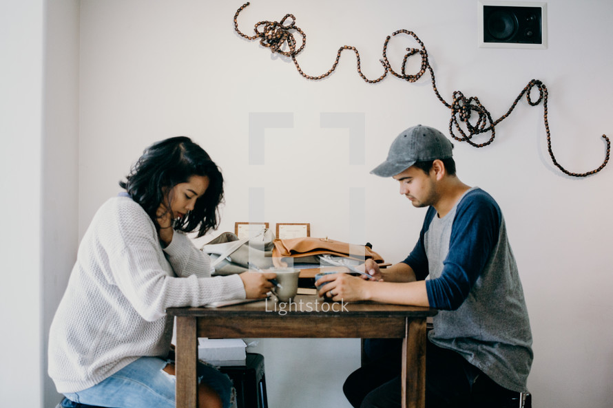couple praying together over coffee 