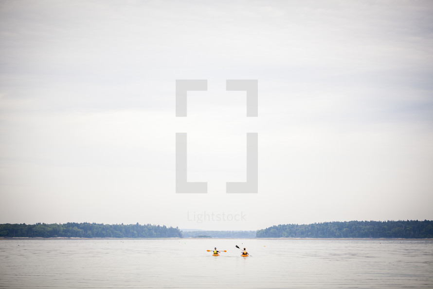 paddling kayaks on a lake 