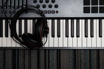 headphones on a  digital piano keyboard 