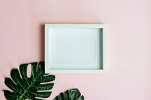 blank frame and tropical leaves 
