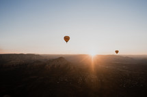 hot air balloons over a canyon 