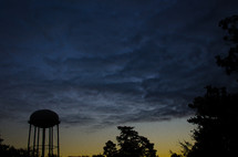 silhouette of a water tower at dusk 
