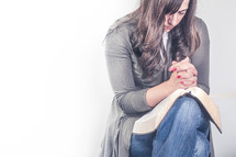 Woman praying with open bible