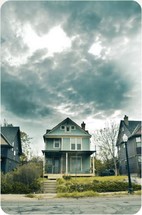 House under a stormy sky.