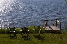 chairs looking out over the water along a shore in Maine 