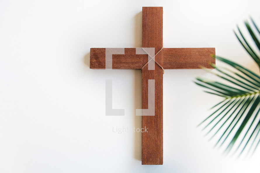 cross and palm leaf on a white background 