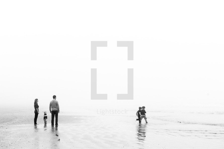 family standing on a beach 