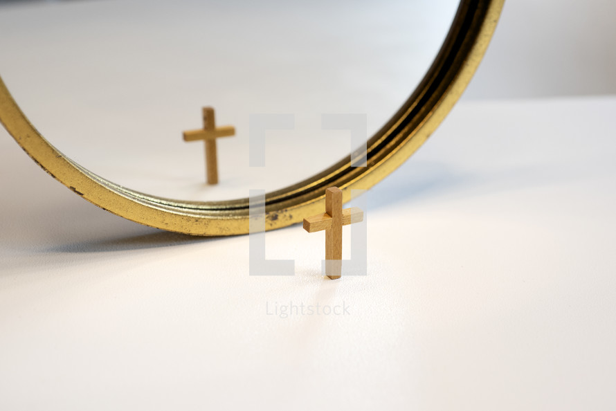 reflection of a cross in a mirror 