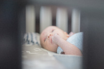 a newborn in a crib 