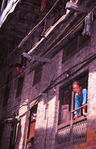 a young girl looking out a window 