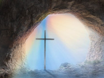 cross and rainbow at the mouth of a cave 