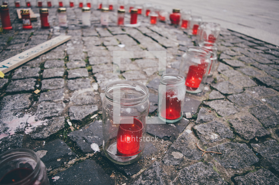 Memorial candles on paved a city street